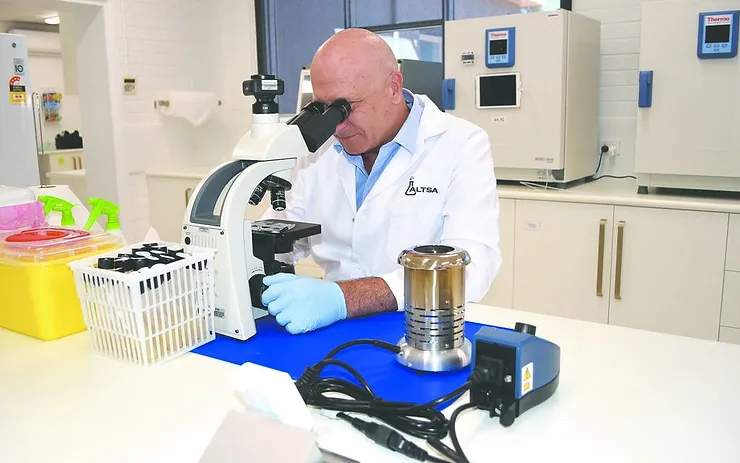 Ray Harris on a microscope